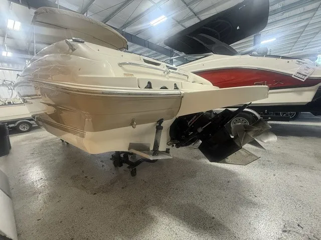 Slide: The Image of A 2001 Sea Ray 260 Signature in a showroom. The hull and drive are visible. - 18