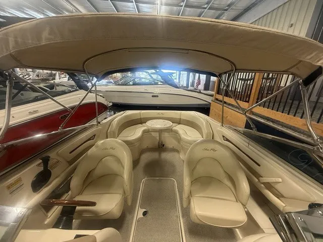 Slide: The Image of The image shows the cockpit of a 2001 Sea Ray 260 Signature with beige seats and a table. - 15