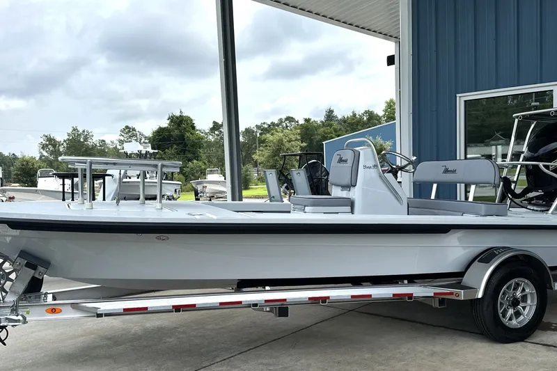 Slide: The Image of 2027 Maverick 18 HPX-V boat on trailer, parked outside a blue building. - 14