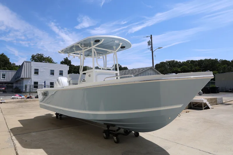 The Image of 2027 Parker 230 Coastal Elite boat on a trailer, parked outdoors under a clear blue sky. - 3