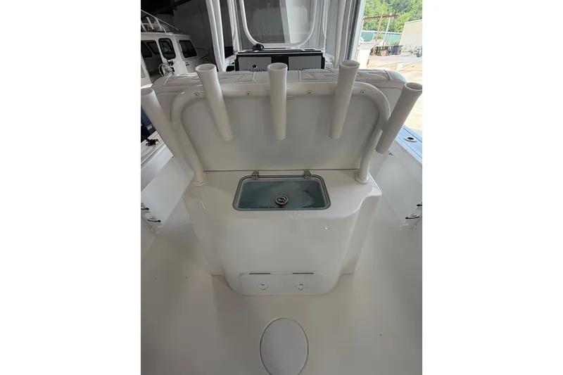 Slide: The Image of 2027 Parker 230 Coastal Elite boat interior with rod holders and storage compartment. - 16