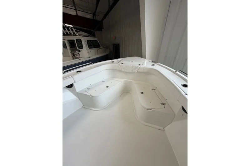 Slide: The Image of 2027 Parker 230 Coastal Elite boat interior with seating and storage compartments. - 17