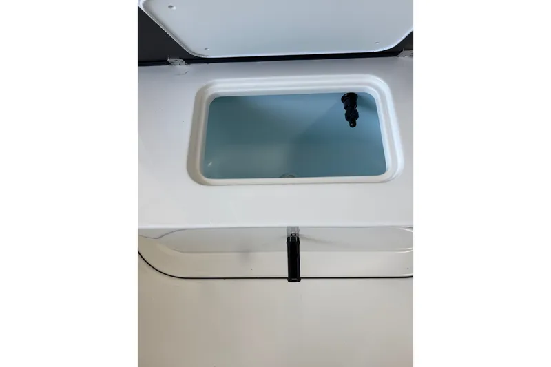 Slide: The Image of Livewell compartment on a 2027 Parker 230 Coastal Elite boat, featuring a sleek design. - 15