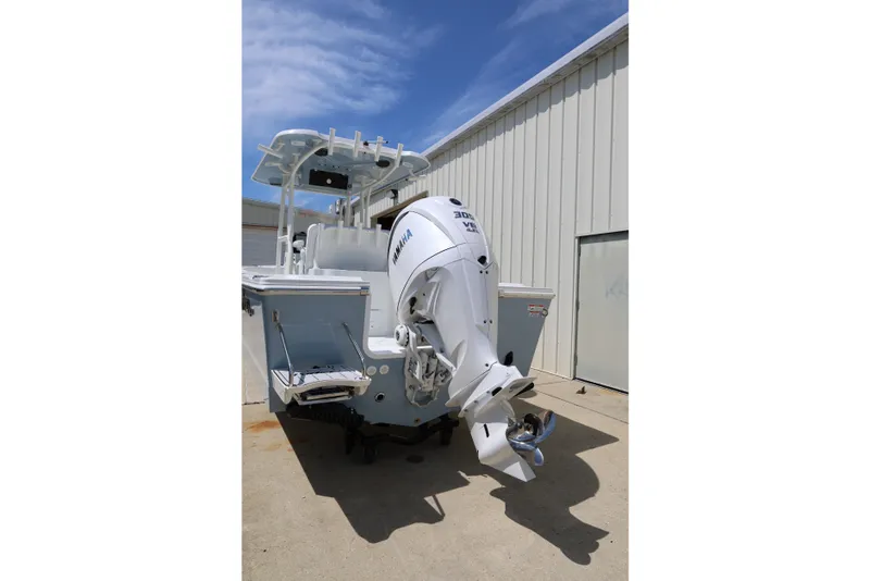 Slide: The Image of 2027 Parker 230 Coastal Elite boat with Yamaha outboard motor, parked outdoors. - 6