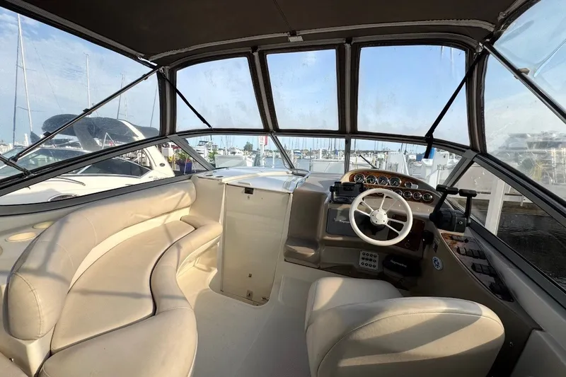 Slide: The Image of Interior view of 1999 Cruisers Yachts 3075 Rogue, featuring helm and seating area. - 3