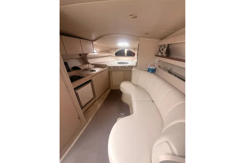 Slide: The Image of 1999 Cruisers Yachts 3075 Rogue interior with kitchenette and curved seating. - 5