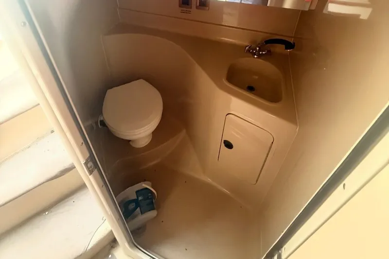 Slide: The Image of 1999 Cruisers Yachts 3075 Rogue bathroom with toilet and sink. - 6