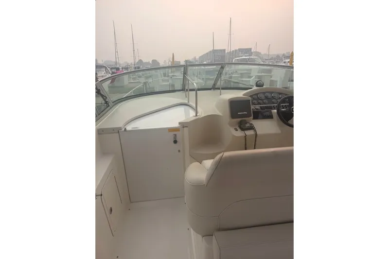 Slide: The Image of 1999 Cruisers Yachts 3075 Rogue cockpit with steering wheel and control panel. - 4