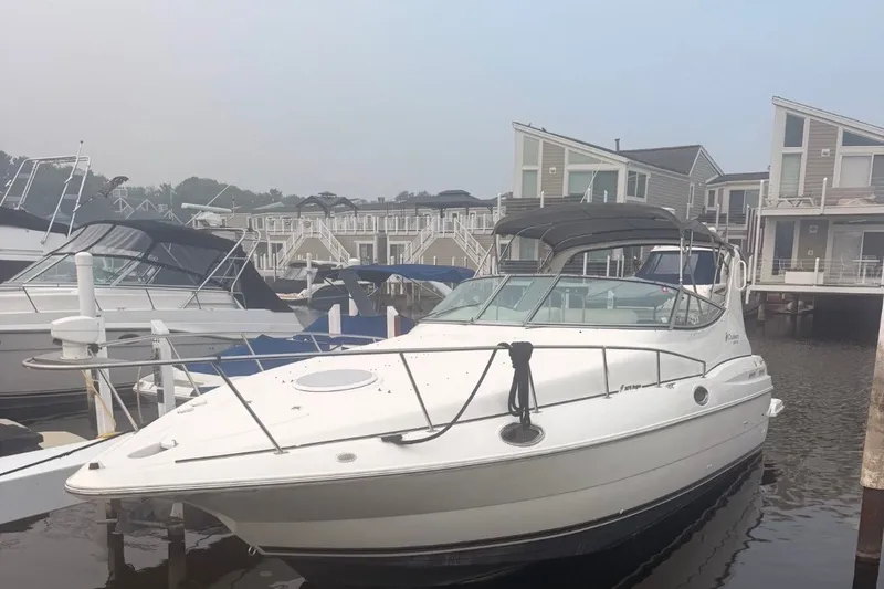 The Image of 1999 Cruisers Yachts 3075 Rogue docked near waterfront homes. - 1