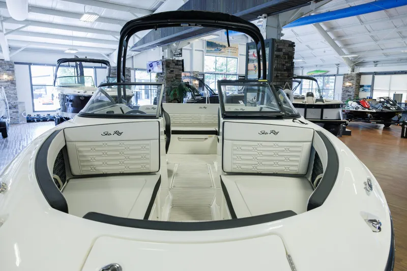 Slide: The Image of 2027 Sea Ray SPX 210 boat interior in showroom, featuring sleek seating and modern design. - 6