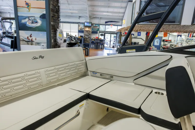 Slide: The Image of Interior view of a 2027 Sea Ray SPX 210 boat in a showroom setting. - 23