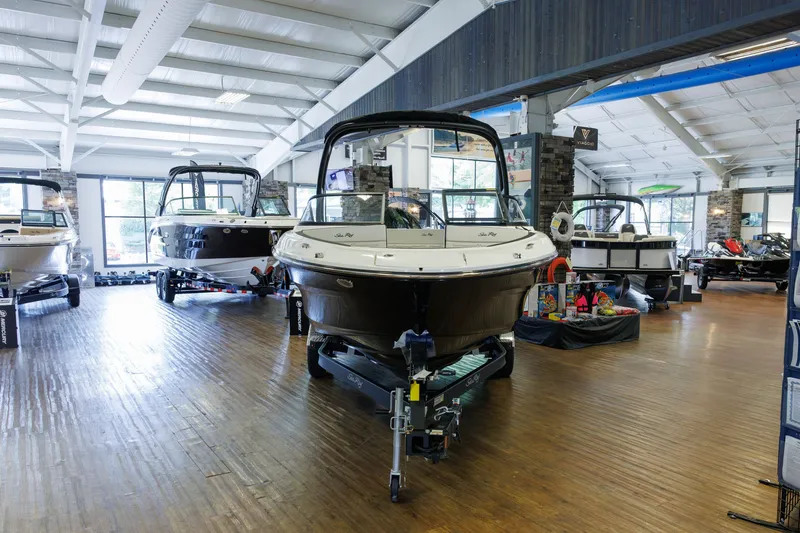 Slide: The Image of 2027 Sea Ray SPX 210 boats displayed in a spacious indoor showroom. - 5