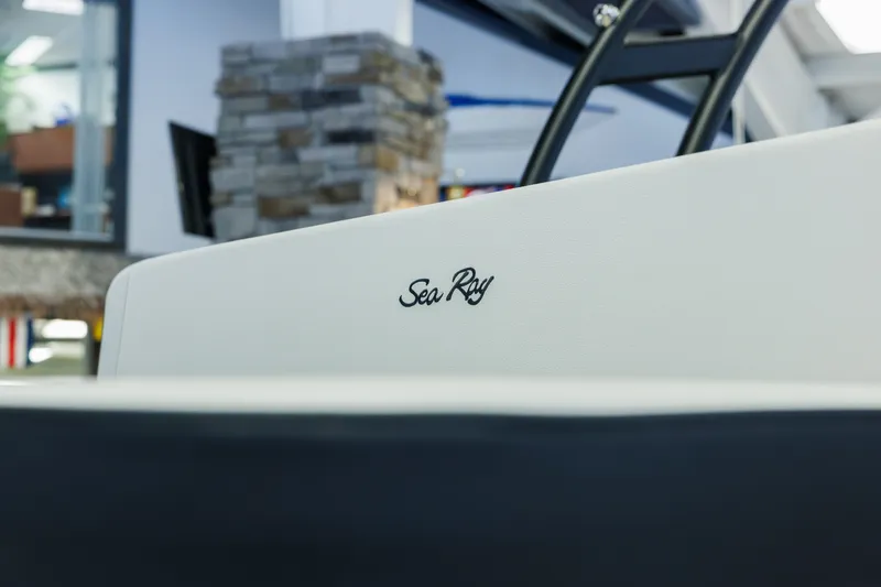 Slide: The Image of 2027 Sea Ray SPX 210 boat interior with logo, modern showroom background. - 8