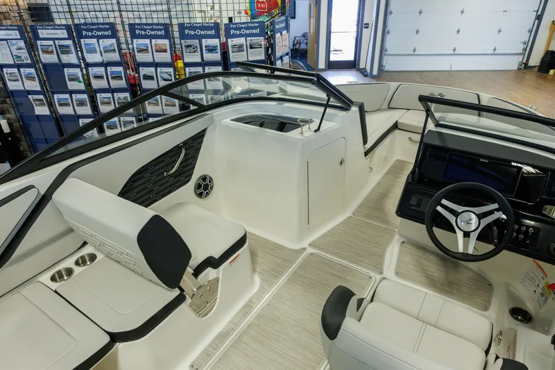 Slide: The Image of 2027 Sea Ray SPX 210 boat interior with modern seating and steering console. - 11