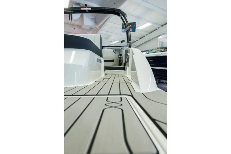 Slide: The Image of 2027 Sea Ray SPX 210 boat interior with sleek deck design in showroom. - 9