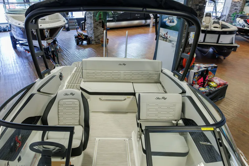 Slide: The Image of 2027 Sea Ray SPX 210 boat interior with luxurious seating in a showroom. - 20