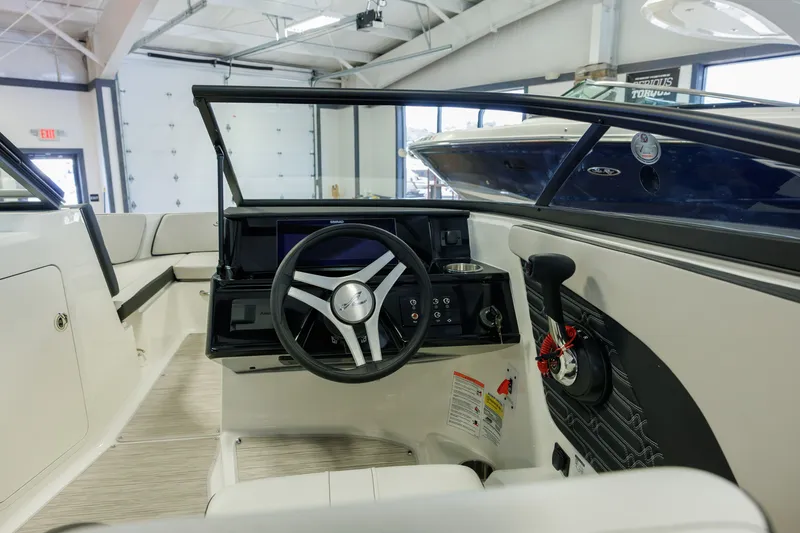 Slide: The Image of Interior view of 2027 Sea Ray SPX 210 boat cockpit with steering wheel and controls. - 12