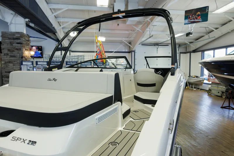 Slide: The Image of 2027 Sea Ray SPX 210 boat displayed in a showroom, showcasing sleek interior design. - 3