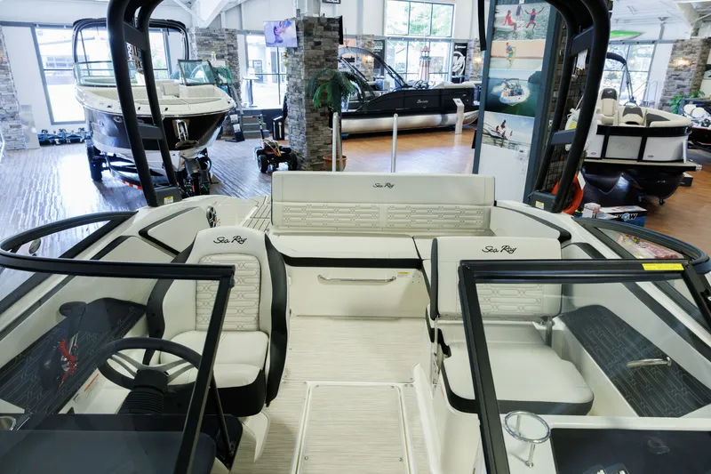 Slide: The Image of Interior view of a 2027 Sea Ray SPX 210 boat in a showroom setting. - 19