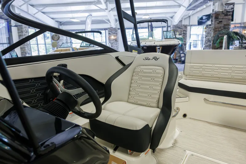 Slide: The Image of Interior of 2027 Sea Ray SPX 210 boat, featuring steering wheel and luxurious seating. - 22