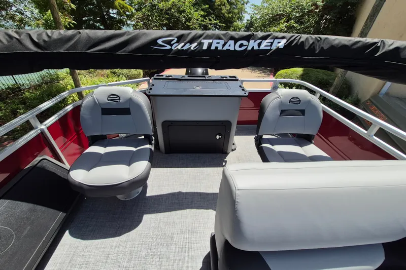 Slide: The Image of 2026 Sun Tracker Sportfish 24 XP3 interior with seating and console, showcasing modern design. - 14