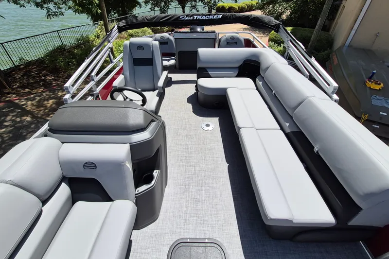 Slide: The Image of 2026 Sun Tracker Sportfish 24 XP3 pontoon boat interior with spacious seating and helm. - 13