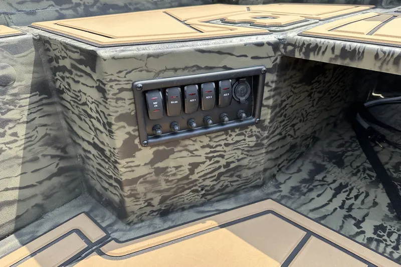 Slide: The Image of Control panel of 2026 Tracker Grizzly 1650 T Prairie Wings Edition boat with camouflage design. - 15