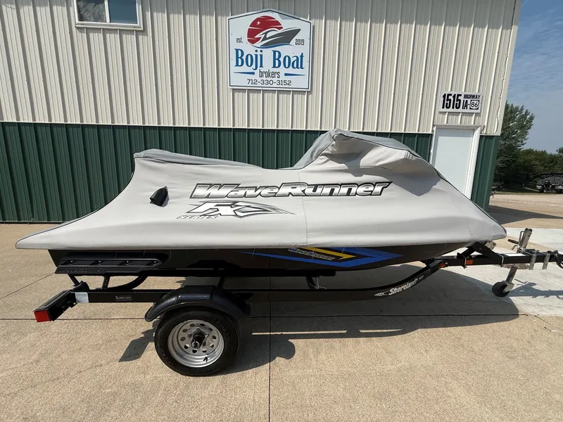 Slide: The Image of A 2016 Yamaha WaveRunner FX Cruiser SVHO on a trailer, covered, in front of a building. - 14