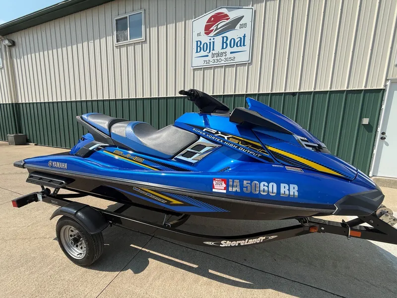 Slide: The Image of A blue 2016 Yamaha WaveRunner FX Cruiser SVHO on a trailer in front of a building. - 1