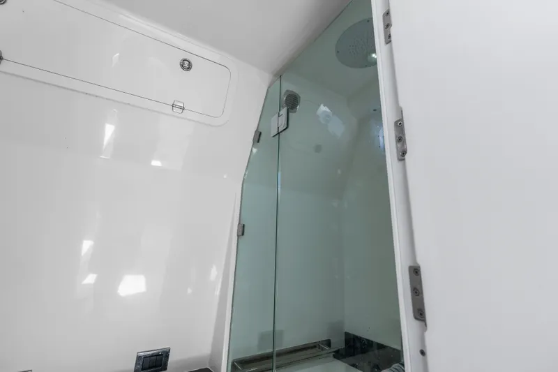 Slide: The Image of Interior of 2020 HCB 53 Suenos yacht featuring a sleek glass shower enclosure. - 63
