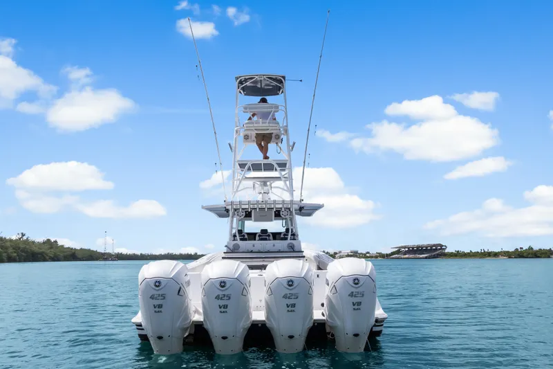 Slide: The Image of 2020 HCB 53 Suenos boat with four powerful outboard engines on water. - 4