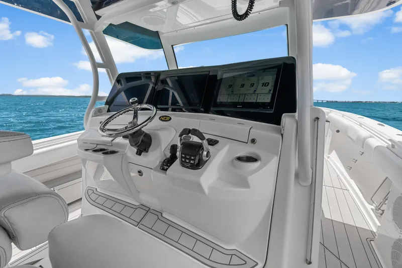 Slide: The Image of 2020 HCB 53 Suenos boat helm with modern controls and ocean view. - 38