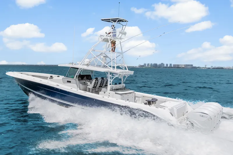 Slide: The Image of 2020 HCB 53 Suenos boat cruising on open water under a clear blue sky. - 18