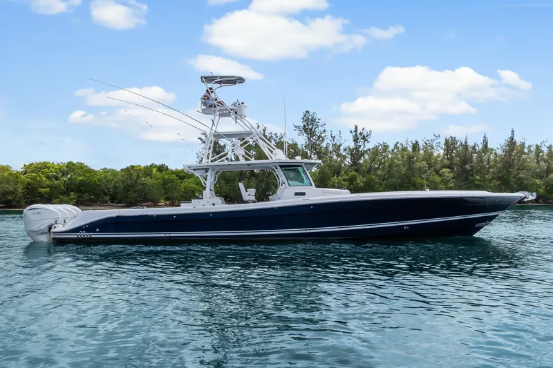 Slide: The Image of 2020 HCB 53 Suenos boat on calm water with lush greenery background. - 6