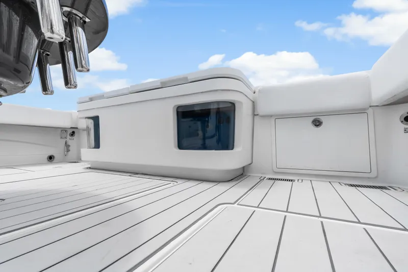 Slide: The Image of 2020 HCB 53 Suenos boat deck with sleek white seating and storage compartments. - 53