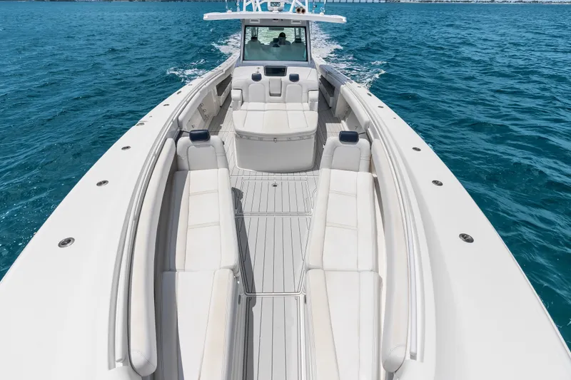 Slide: The Image of 2020 HCB 53 Suenos luxury boat cruising on clear blue water. - 27