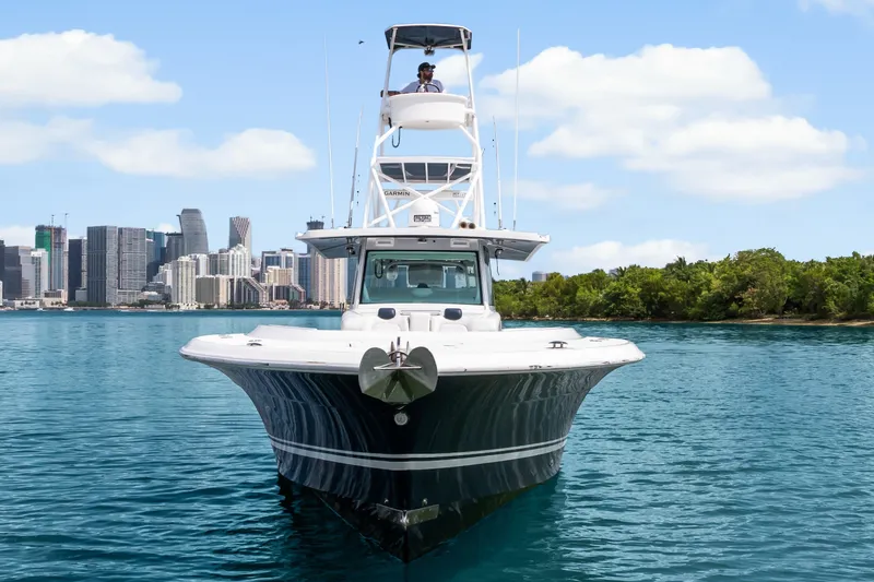 Slide: The Image of 2020 HCB 53 Suenos boat on water with city skyline and greenery in background. - 8