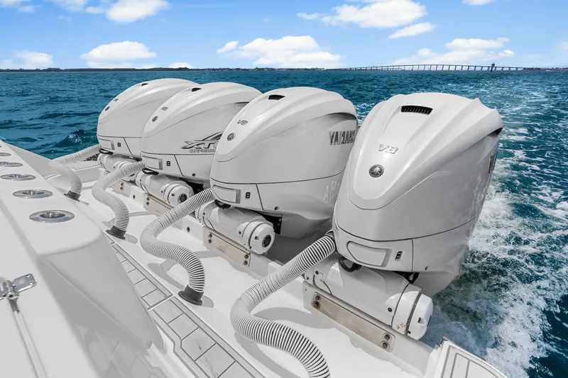 Slide: The Image of Four Yamaha outboard engines on a 2020 HCB 53 Suenos boat in open water. - 65