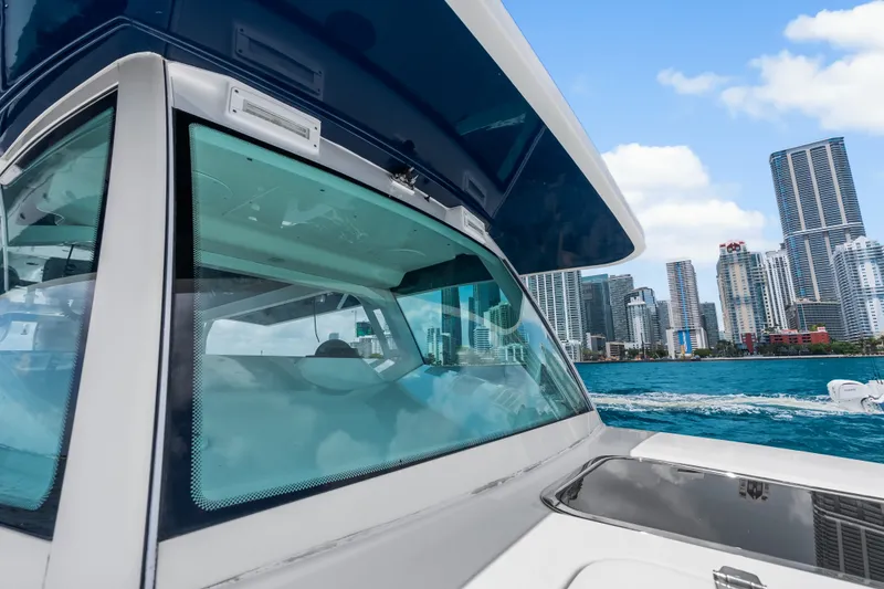 Slide: The Image of 2020 HCB 53 Suenos boat cruising near city skyline with blue sky and water. - 36