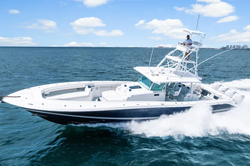 Slide: The Image of 2020 HCB 53 Suenos boat cruising on open water under a clear blue sky. - 12