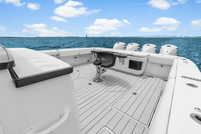 Slide: The Image of 2020 HCB 53 Suenos boat deck with multiple engines, on open water under blue sky. - 51