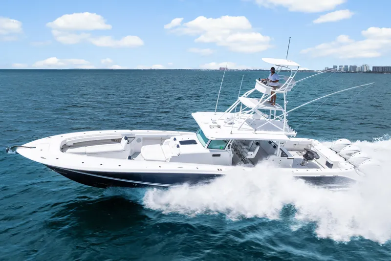 Slide: The Image of 2020 HCB 53 Suenos boat cruising on open water under a clear sky. - 11