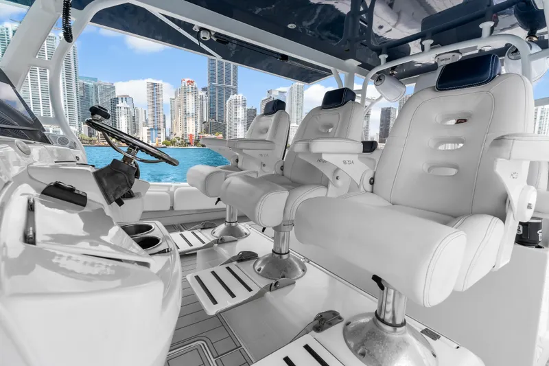 Slide: The Image of Luxury helm of 2020 HCB 53 Suenos boat with city skyline view. - 37