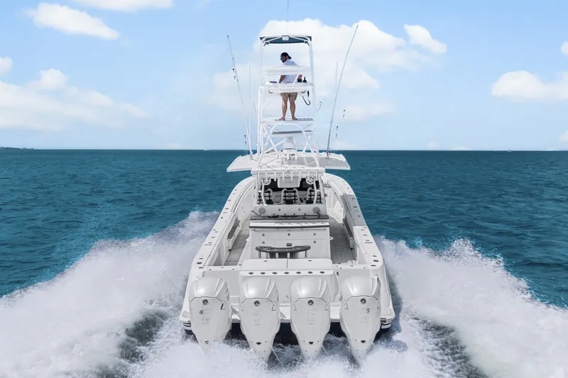Slide: The Image of 2020 HCB 53 Suenos boat cruising on open water, rear view with clear skies. - 17