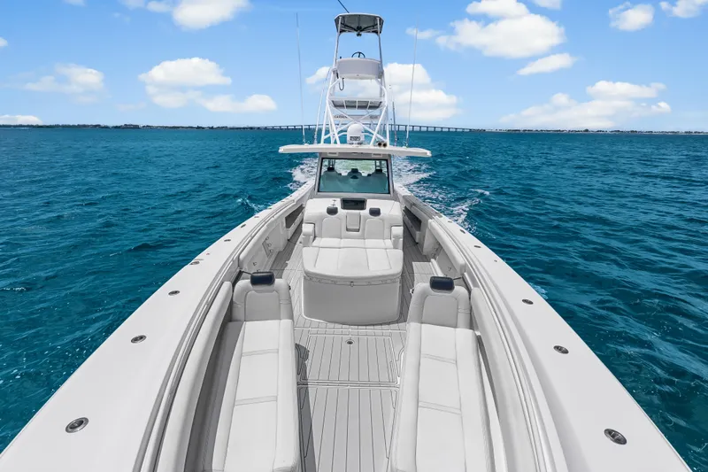 Slide: The Image of 2020 HCB 53 Suenos luxury boat cruising on clear blue ocean waters. - 26