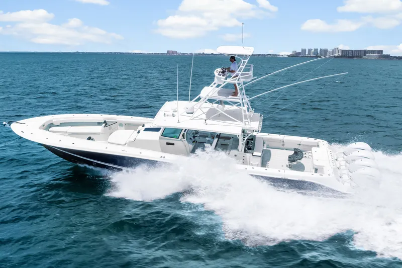 Slide: The Image of 2020 HCB 53 Suenos boat cruising on open water under a clear sky. - 10