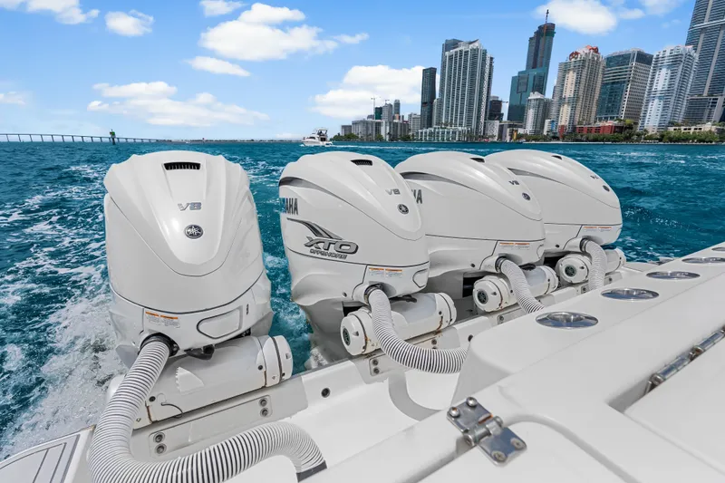 Slide: The Image of Four Yamaha V8 outboard engines on a 2020 HCB 53 Suenos boat, city skyline in background. - 66