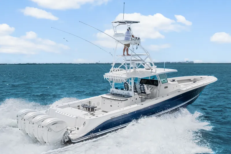 Slide: The Image of 2020 HCB 53 Suenos boat cruising on open water with multiple outboard engines. - 21