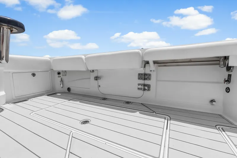 Slide: The Image of 2020 HCB 53 Suenos boat deck with white seating and clear blue sky. - 55