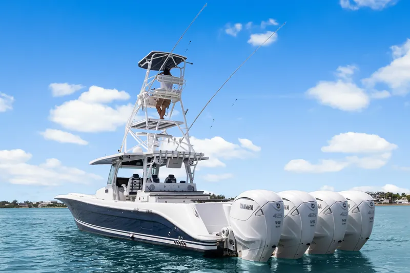 Slide: The Image of 2020 HCB 53 Suenos boat with four Yamaha engines on clear blue water. - 3